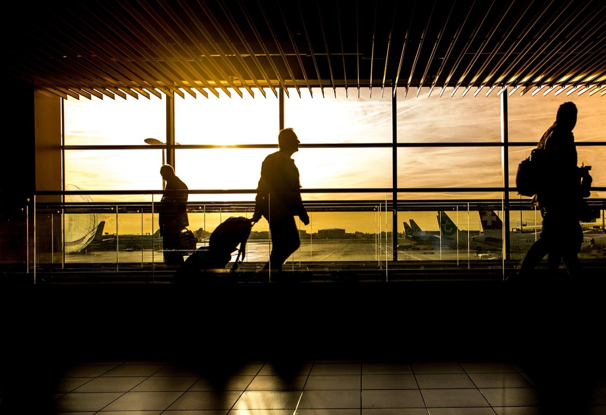 Palau airport terminal with travelers and luggage