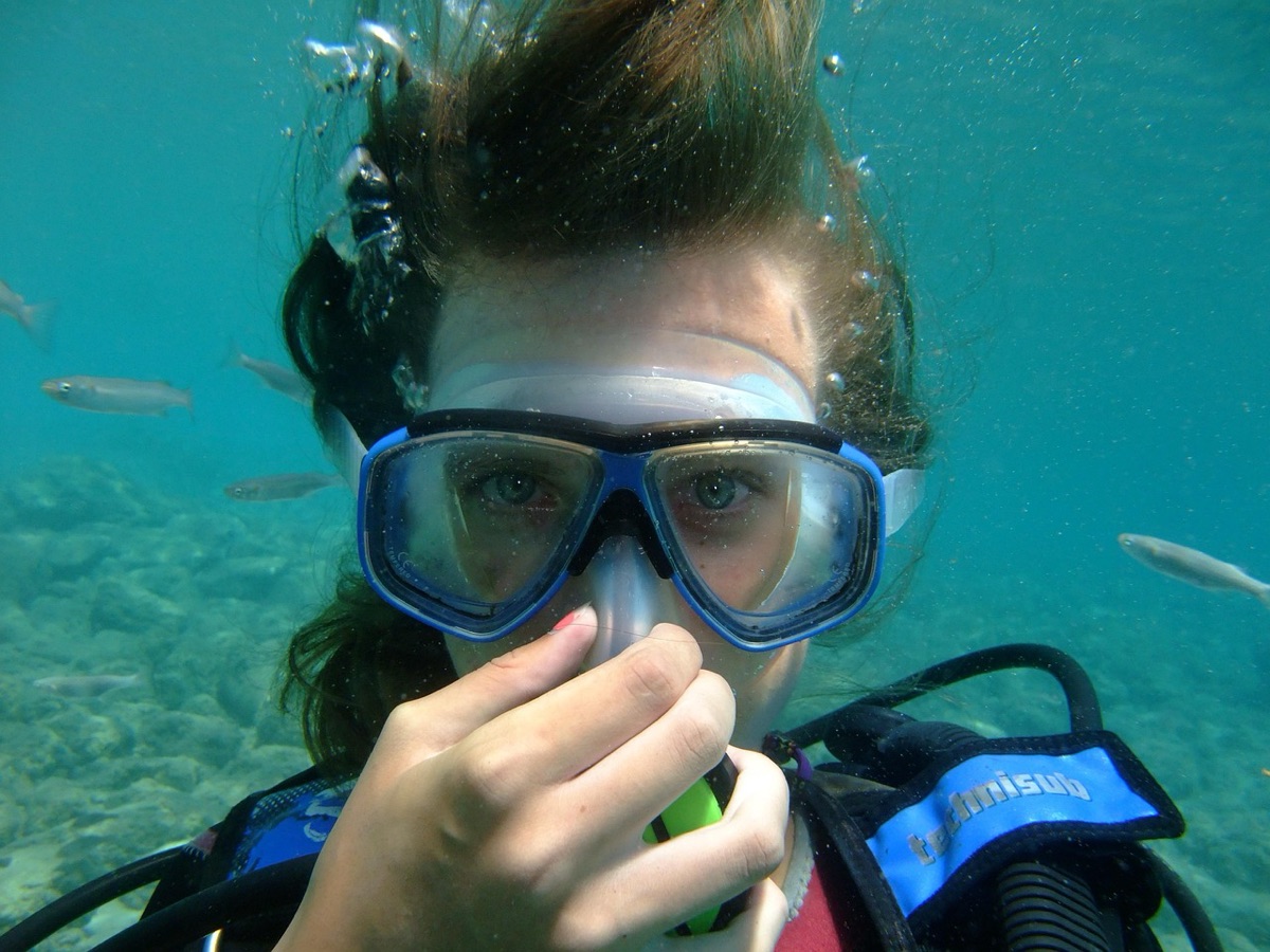 scuba diver checking regulator